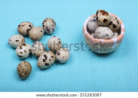 Quail eggs on the table. Eggs on a turquoise background. Composition with quail eggs. Diet food. Vitamin product.