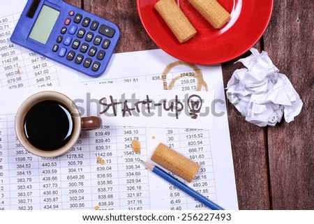 Workplace office worker who completes the project. Stress at work. Start up business, working hard. Untidy workplace. Chips, coffee, crumpled paper, pencil, calculator. Office desk. Accountant job.