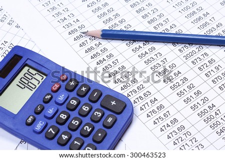 Calculator, tables with numbers and a pencil. Accounting documents on the table. Read, keep accounts. Start up, business, entrepreneurship. Blue calculator and pencil. Balance sheet.