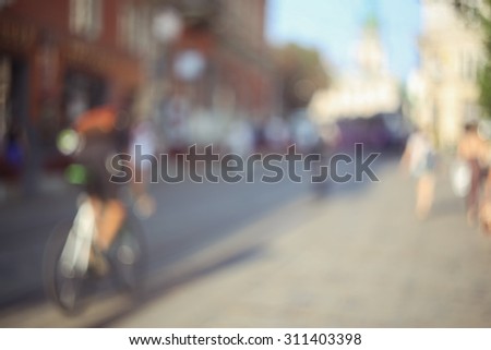 City life. The cyclist traffic in the city. People on the street. Background. Urban background. Blur, bokeh. Open aperture. Urban space. Urban background. City tourism.
