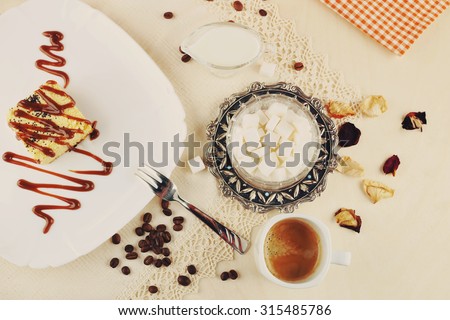 Cheese dessert. Delicious cheesecake and caramel. Caramel sauce on the cake. Baking, dessert, confectionery.Coffee beans and a sweet dessert. Coffee and dessert. Sweet food. Coffee and milk.
