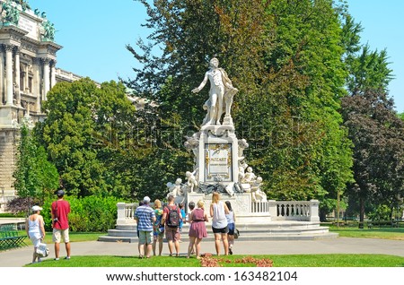 VIENNA, AUSTRIA - JULY 28: Tourists visit the monument to Mozart on July 28, 2013 in Vienna, Austria. The Mozart monument in Vienna was built by the sculptor Viktor Tilgner in 1896.