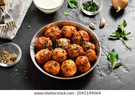 Bombay potatoes. Pan fried little baby potatoes with jeera seeds and coriander in bowl over dark background. Popular indian dish. 