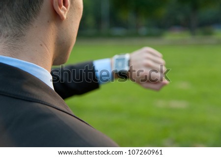 Man checking the time in the park