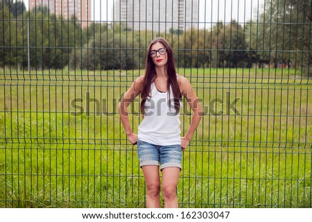 Portrait Of Young Woman Wearing Hipster Glasses On Sport Playground