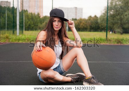Sexy Woman Holding Basketball In Hand On Sports Playground