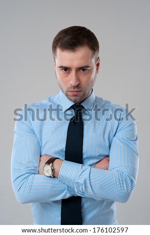 Angry emotion on face of business man isolated on grey background
