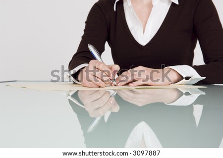 Businesswoman writing a note.