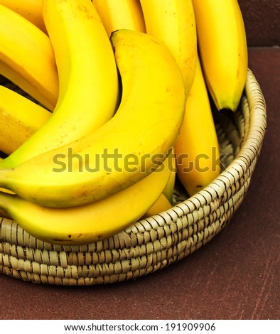 Ripe yellow bananas in small basket