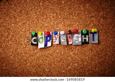 Copyright - Cut out letters pinned on a notice board.