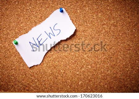 News written on torn paper - pinned on cork board.