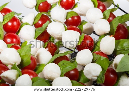 Appetizer. baby mozzarella with cherry tomatoes and basil leaves. Creative cuisine. close-up