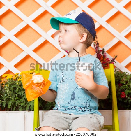 Young little and cute boy pictured with glass of milk
