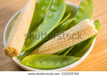Seasonal fresh vegetables including corn, pea pods