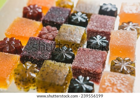 Many different fruit paste candies. Whole background. Selective focus. warm colors