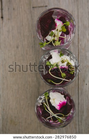 Vegetarian aperitif with beet, goat cheese and soy sprouts