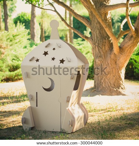 Cardboard toy spaceship in the park. Eco concept