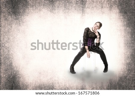 gothic woman sitting in an abstract room