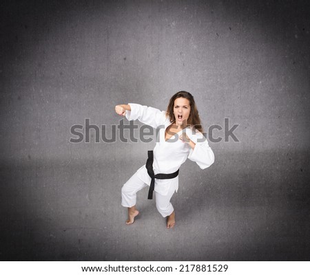 angry judo girl in lateral position ready to hit