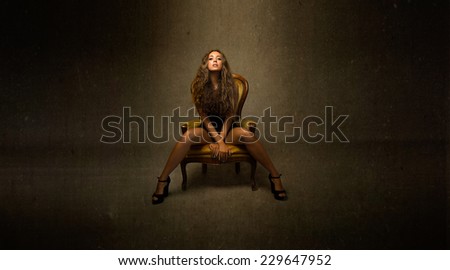 girl with open legs sitting whit vintage light on face