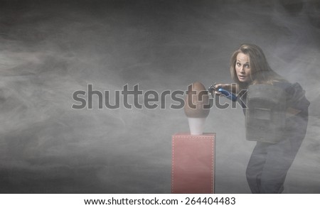 welder with easter chocolate egg, humor image for woman in dark background