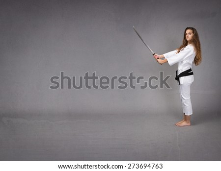 lateral viewing for a karate girl, gray background