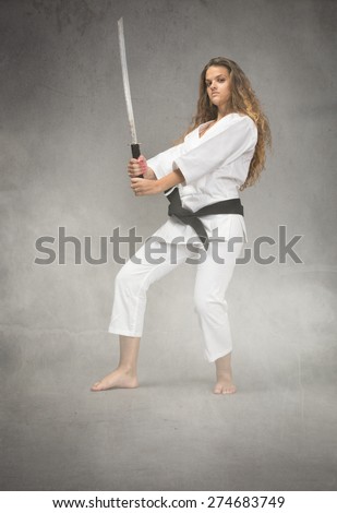 karate girl with sword on hand, cloudy room