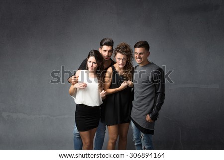 group of friends with bad faces, dark background