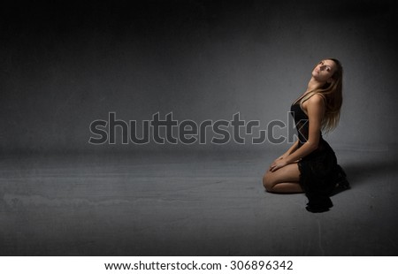 nice girl sitting on knees, dark room