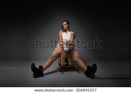 girl riding a rocking horse, open legs