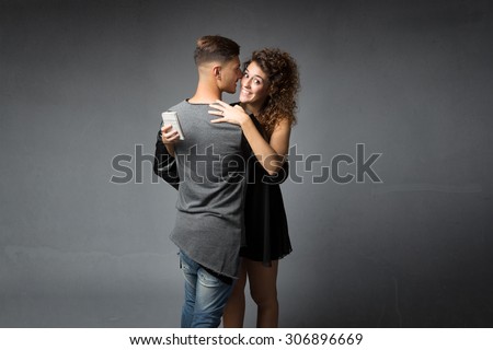 girl cheating wiht phone on hand, dark background