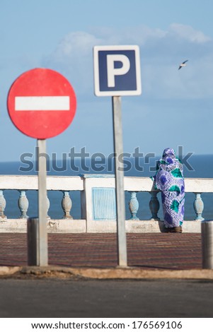 Woman watching the Sea in Sidi Ifni, Morocco