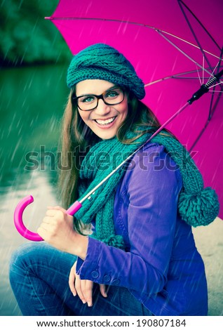girl with pink umbrella in the rain