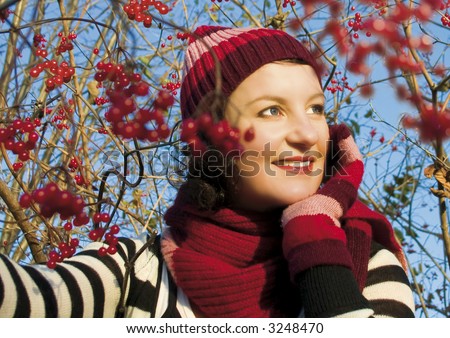 girl beside a red berry-bush in autumn. More pictures of her in my portfolio.