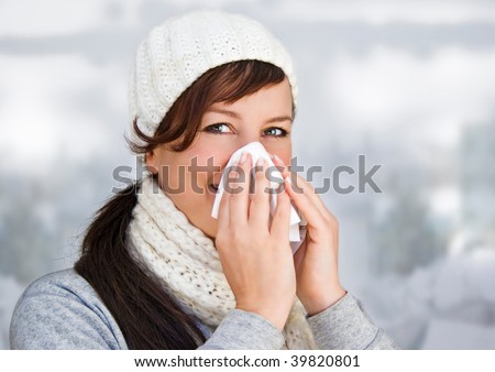 woman with a cold holding a tissue (without snow in background)