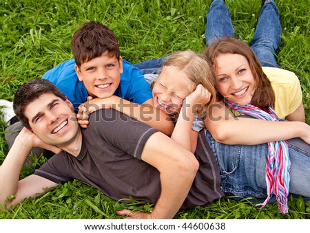 cute young family having fun in the nature
