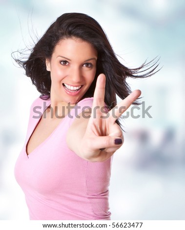 beautiful young girl making a victory sign