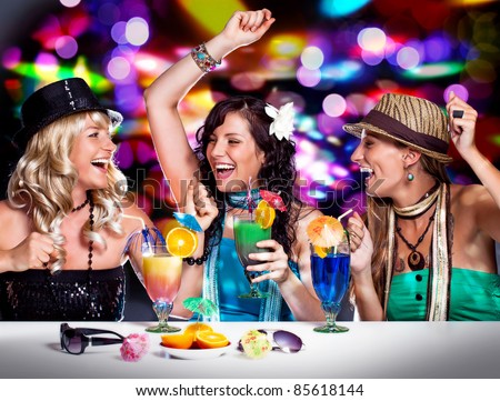 three beautiful girls celebrating in a club