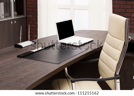 laptop on a desk in a modern office