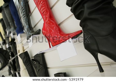 Red boot on a high heel in shoe shop