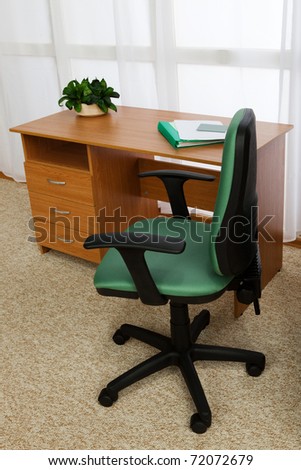 desk with drawers and a chair in a modern office