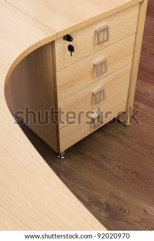 wooden desk with drawers in a modern office