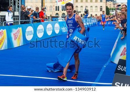 STOCKHOLM - AUG, 24: The winner Jonathan Brownlee crossing the finish line, Javier Gomez in the background in the Mens ITU World Triathlon Series event Aug 24, 2012 in Stockholm, Sweden