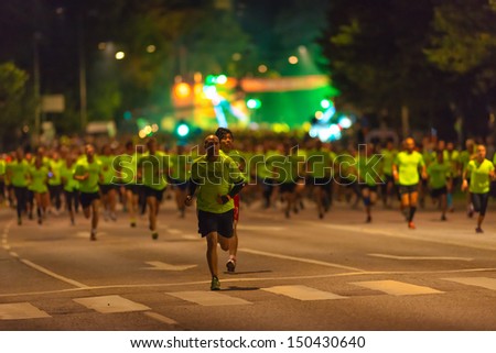 STOCKHOLM - AUG, 17: Start of one of many groups in the Midnight Run (Midnattsloppet) event over 10 km with a man taking the lead of that group. Aug 17, 2013 in Stockholm, Sweden