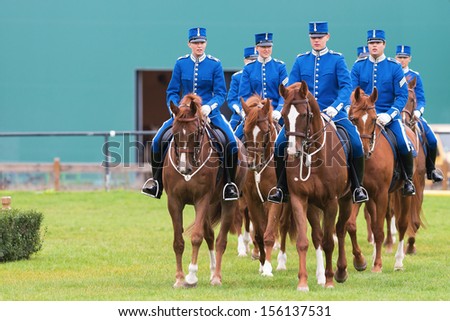 STOCKHOLM - SEPT, 22: A group of riders from the mounted guard entering the arena in The Mounted Guard event for the public in Ryttarstadion Sept 22, 2013 in Stockholm, Sweden