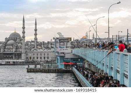 ISTANBUL - NOV, 21: Fishermen at the crowded Galata bridge with restaurants on the lower deck in Istanbul, Nov 21, in Istanbul, Turkey 2013