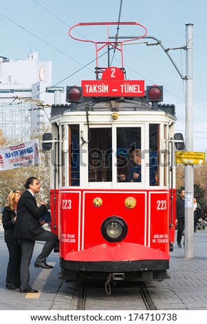 ISTANBUL - NOV, 21: A red classic tram with passengers entering at the Taksim square in the Beyoglu district of Istanbul, Nov 21, in Istanbul, Turkey 2013