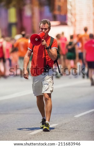 STOCKHOLM - AUG, 16: Official with horn announcing close to start of the Midnight Run (Midnattsloppet) event. Aug 16, 2014 in Stockholm, Sweden