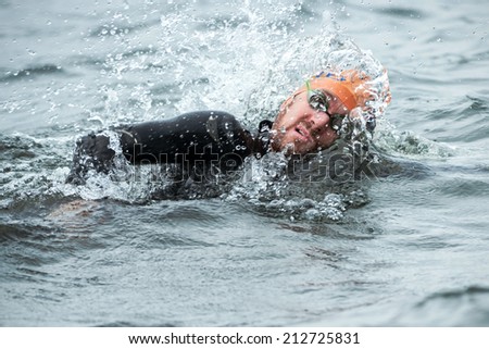STOCKHOLM - AUG, 23: Closeup of a triathlete in the mens swimming in the cold water at the Mens ITU World Triathlon Series event Aug 23, 2014 in Stockholm, Sweden