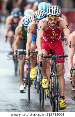 STOCKHOLM - AUG, 23: Alois Knabl from Austria in wet weather with a group at the Mens ITU World Triathlon Series event August 23, 2014 in Stockholm, Sweden